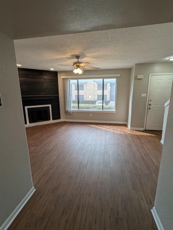 514 East Belt Line Road, Unit B13 DeSoto, TX 75115 - Photo 2 of 28 an empty room with wooden floor fireplace and windows