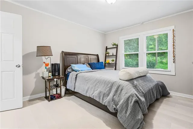 a bed sitting in a bedroom next to a window