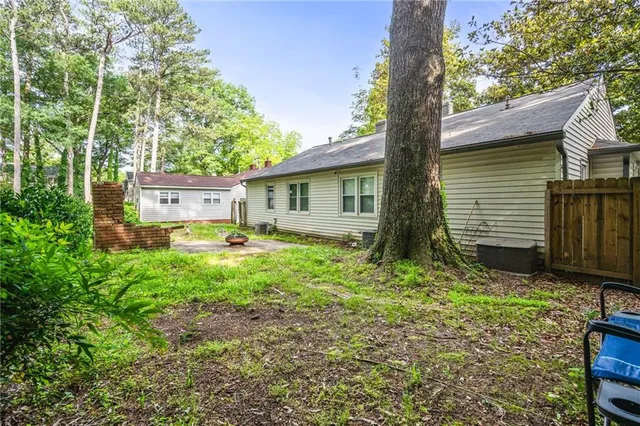 a living room with furniture a fireplace and a table