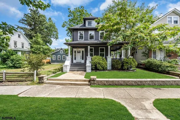 a view of empty room with wooden floor and window
