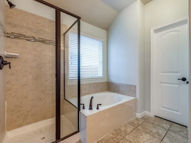a bathroom with a bathtub and shower