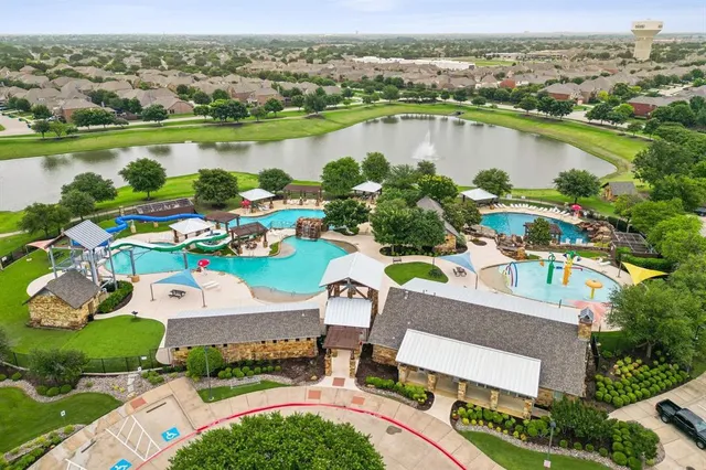 an aerial view of a house with outdoor space and lake view