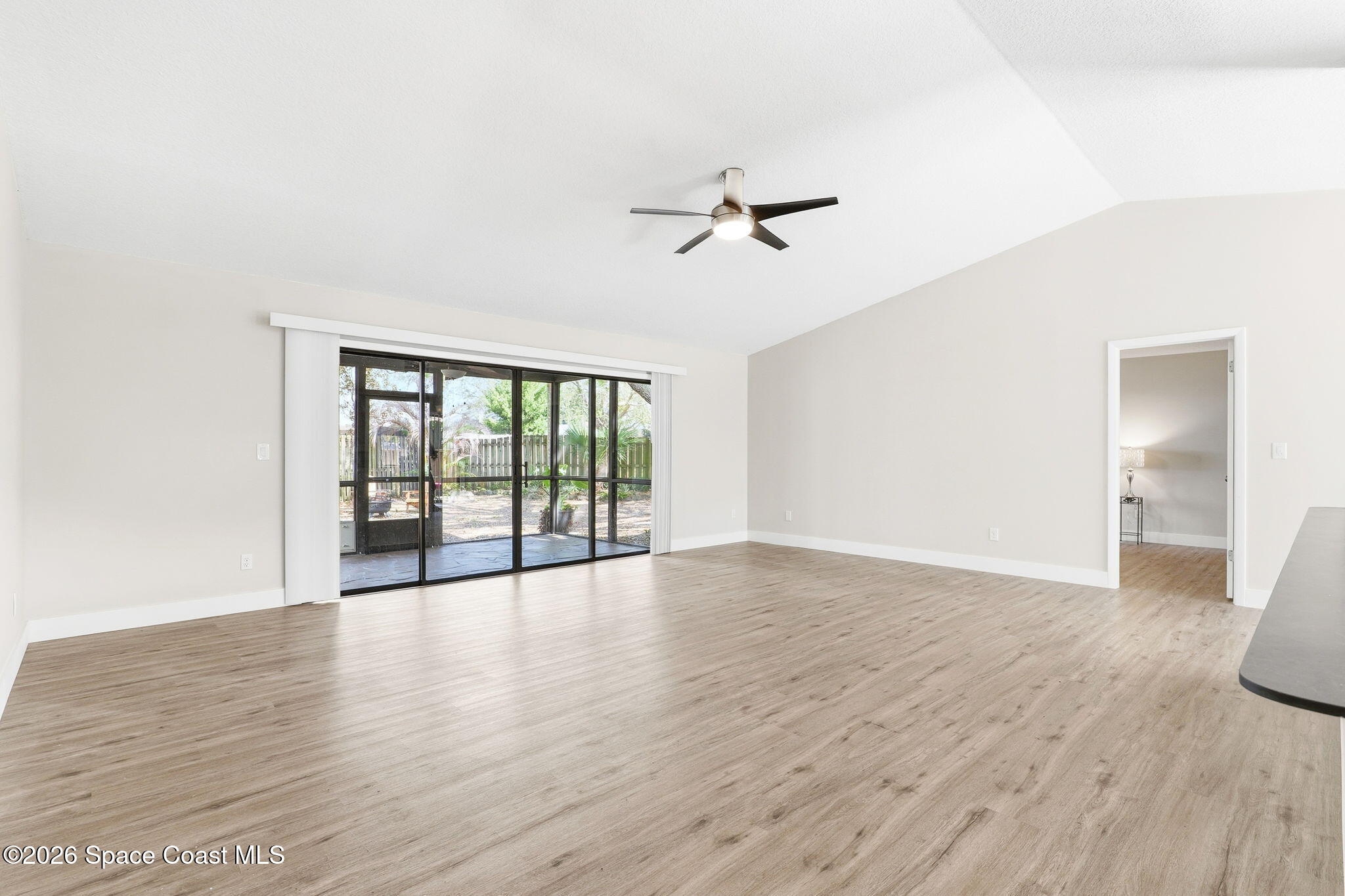 984 Bayberry Lane Rockledge, FL 32955 - Photo 15 of 39 a view of an empty room with wooden floor and a window
