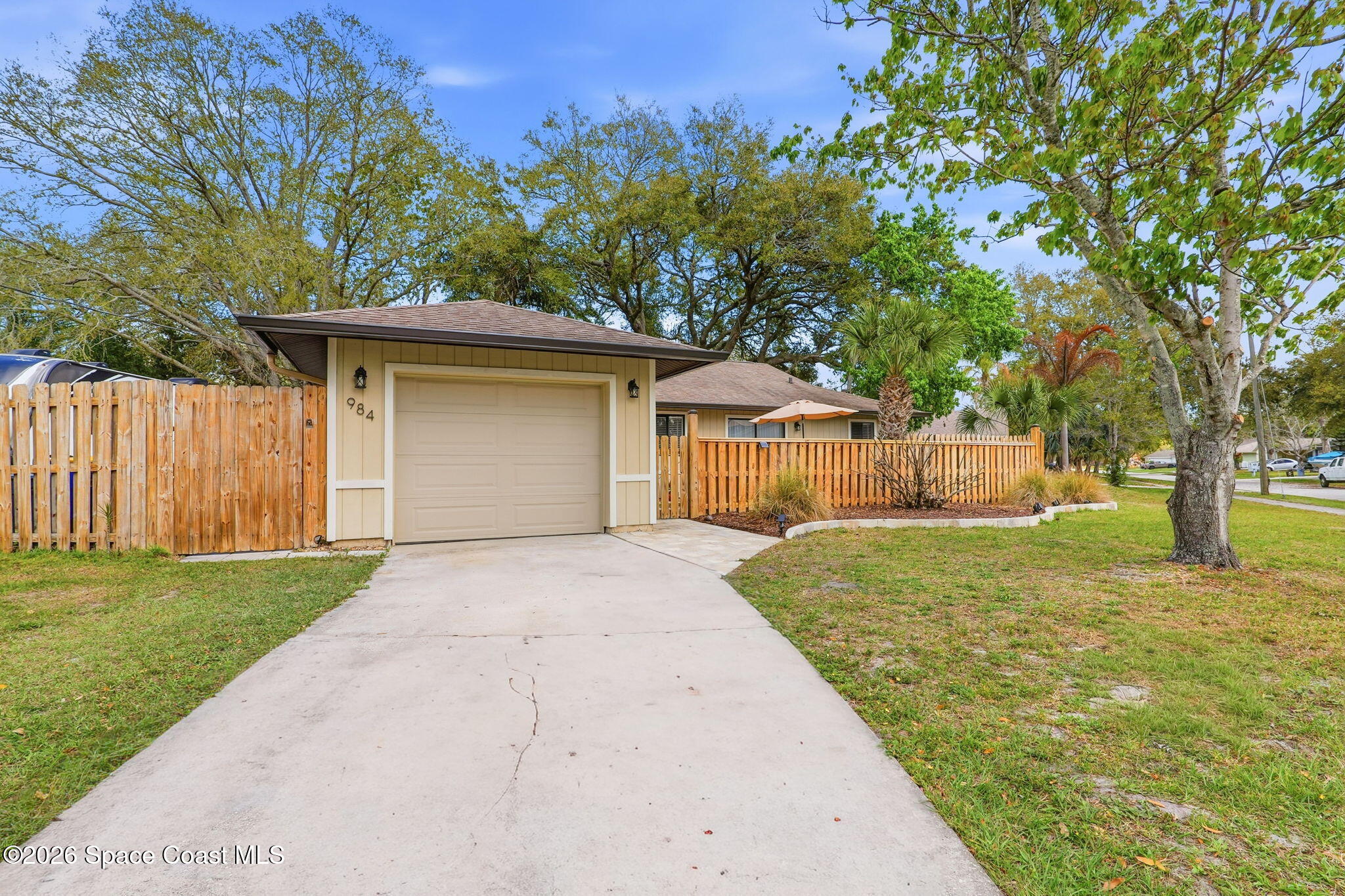 984 Bayberry Lane Rockledge, FL 32955 - Photo 2 of 39 a front view of a house with yard and tree