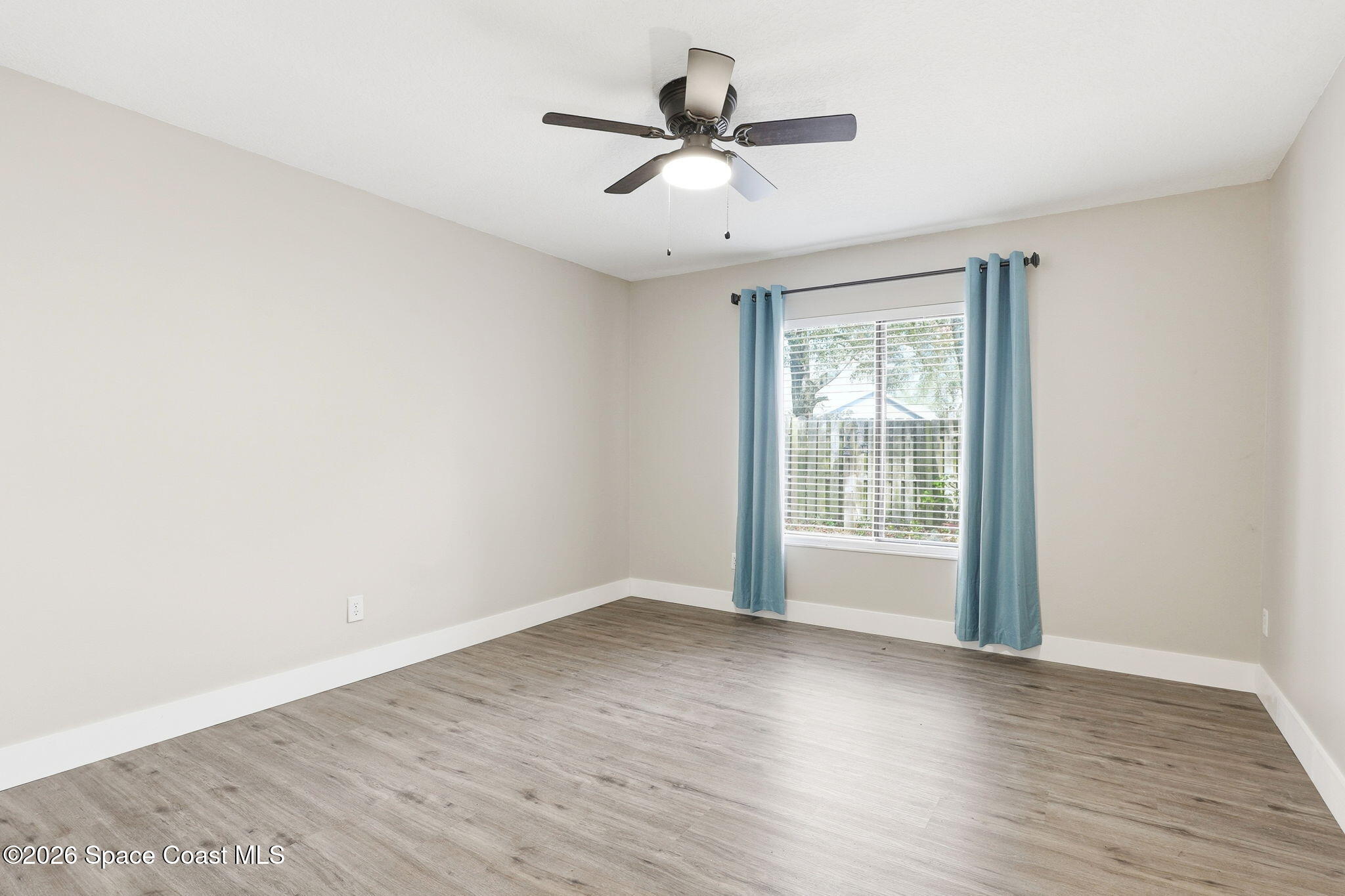 984 Bayberry Lane Rockledge, FL 32955 - Photo 25 of 39 an empty room with wooden floor and windows