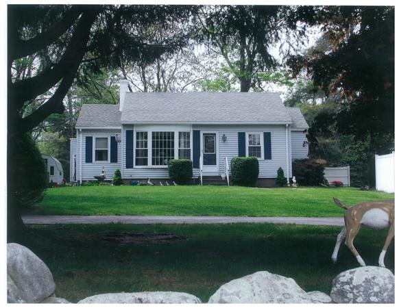 a front view of a house with a yard