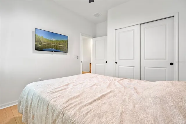 a bedroom with a bed and a painting