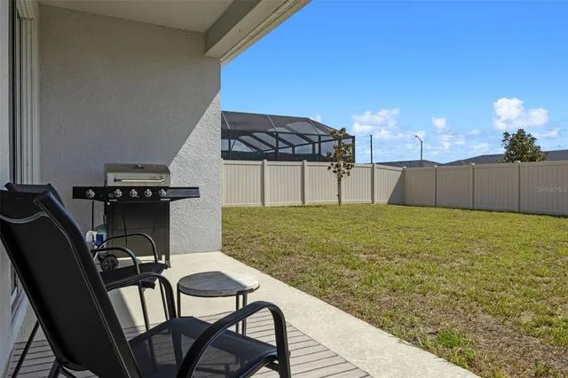 a view of a chairs and table in patio