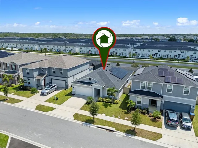an aerial view of a house with a garden and plants