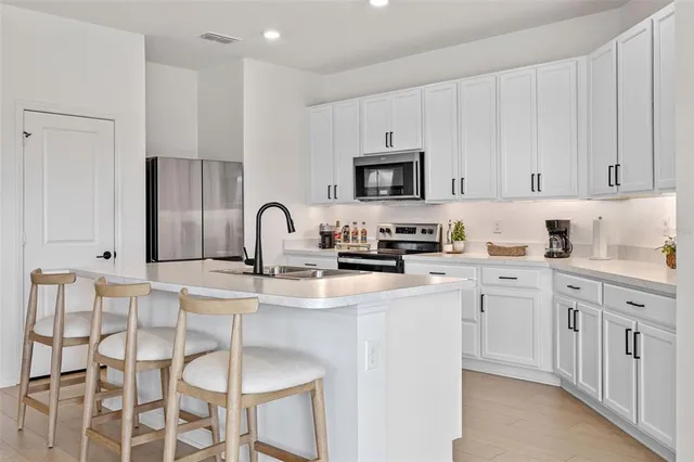 a kitchen with stainless steel appliances granite countertop a sink and cabinets