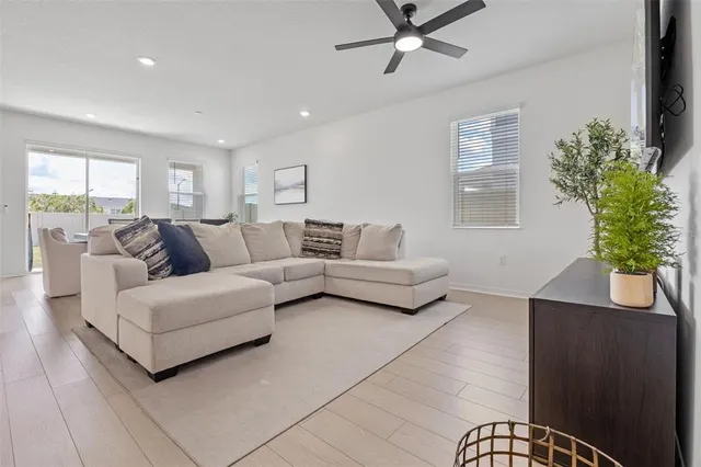 a living room with furniture and a potted plant