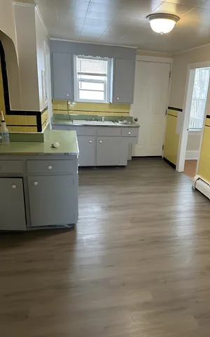 a room with wooden floor and window