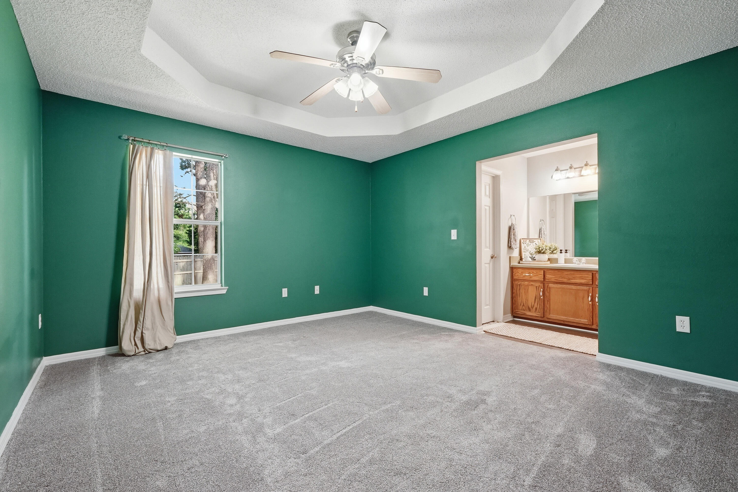 3033 Cabela Lane Crestview, FL 32539 - Photo 17 of 32 a view of an empty room with a window and a ceiling fan