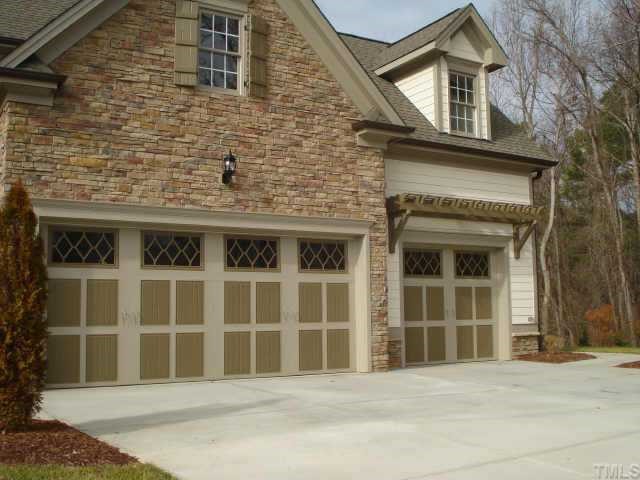 7611 Devere Court Raleigh, NC 27613 - Photo 12 of 12 3 CAR GARAGE W/ A TRELLIS AND DECORATIVE DOORS