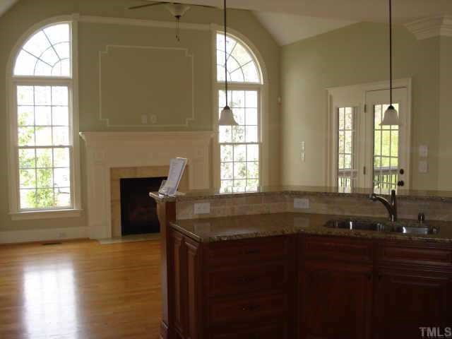 7611 Devere Court Raleigh, NC 27613 - Photo 10 of 12 INCREDIBLE HEARTH ROOM WHICH IS OPEN TO THE KITCHEN WITH BEAUTIFUL WINDOWS AND ANOTHER FIREPLACE