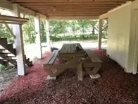a view of a porch with chairs and backyard