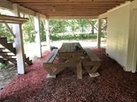 496 Campground Road Trinity, TX 75862 - Photo 13 of 22 a view of a porch with chairs and backyard