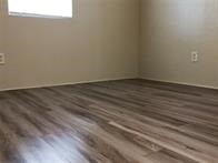 496 Campground Road Trinity, TX 75862 - Photo 10 of 22 a view of an empty room with wooden floor and a window