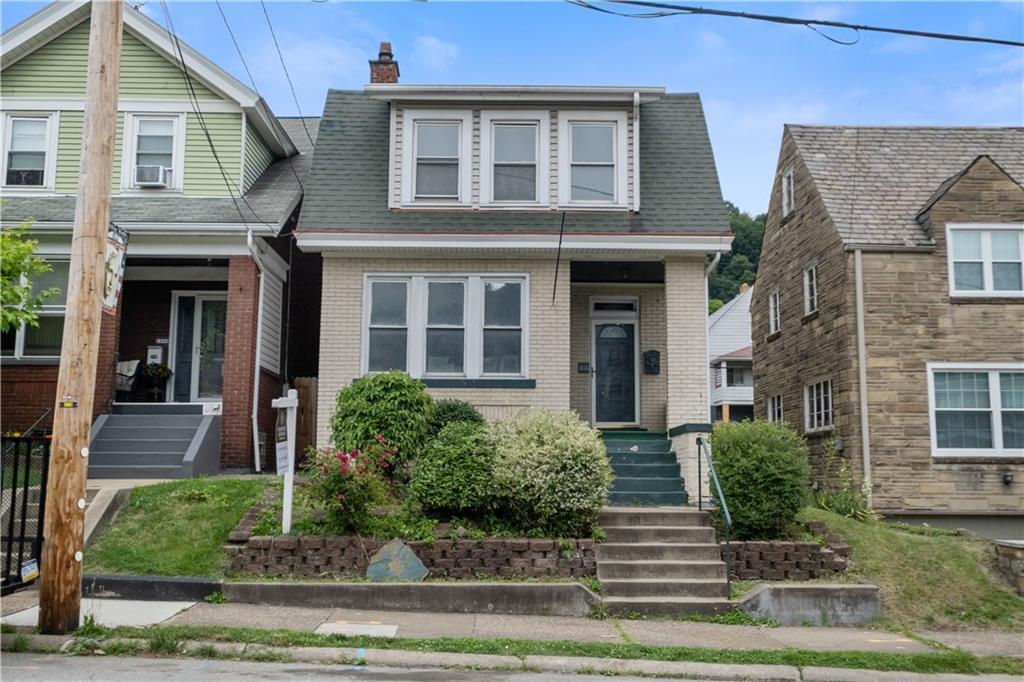 1306 Broadway Avenue McKees Rocks, PA 15136 - Photo 1 of 33 a front view of a house with garden