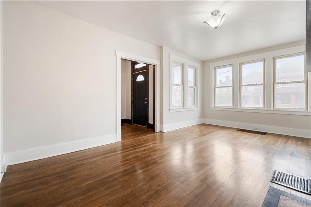 1306 Broadway Avenue McKees Rocks, PA 15136 - Photo 11 of 33 an empty room with wooden floor and windows