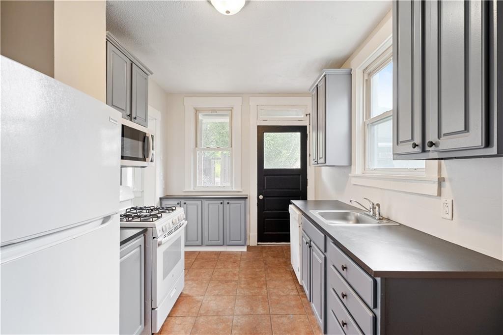 1306 Broadway Avenue McKees Rocks, PA 15136 - Photo 12 of 33 a kitchen with stainless steel appliances granite countertop a sink stove and refrigerator