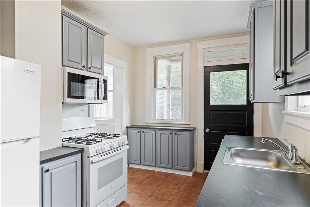 1306 Broadway Avenue McKees Rocks, PA 15136 - Photo 13 of 33 a kitchen with stainless steel appliances granite countertop a sink stove and refrigerator