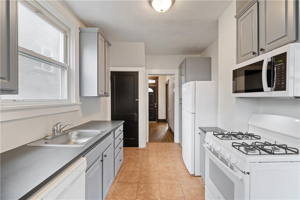 1306 Broadway Avenue McKees Rocks, PA 15136 - Photo 14 of 33 a kitchen with stainless steel appliances a sink stove and refrigerator