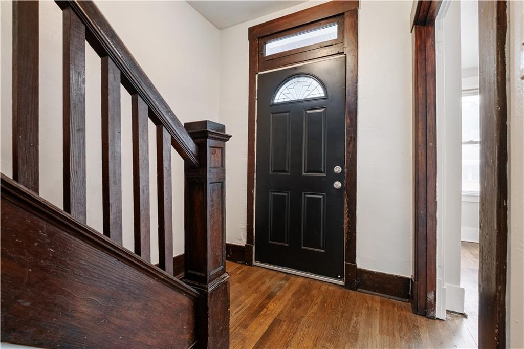 1306 Broadway Avenue McKees Rocks, PA 15136 - Photo 15 of 33 a view of a hallway with wooden floor and staircase