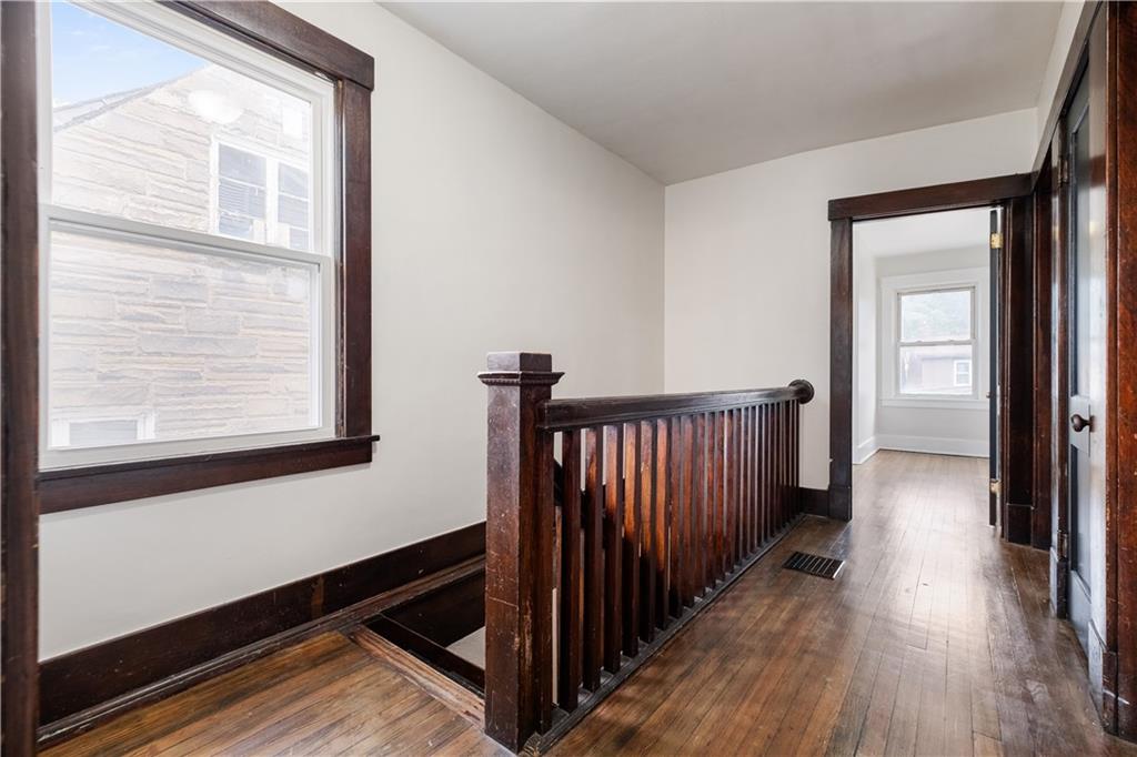 1306 Broadway Avenue McKees Rocks, PA 15136 - Photo 17 of 33 a view of a hallway with wooden floor and a window