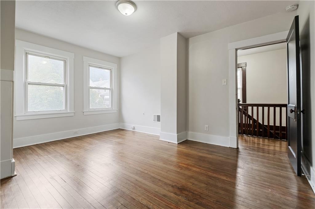 1306 Broadway Avenue McKees Rocks, PA 15136 - Photo 19 of 33 an empty room with wooden floor and windows