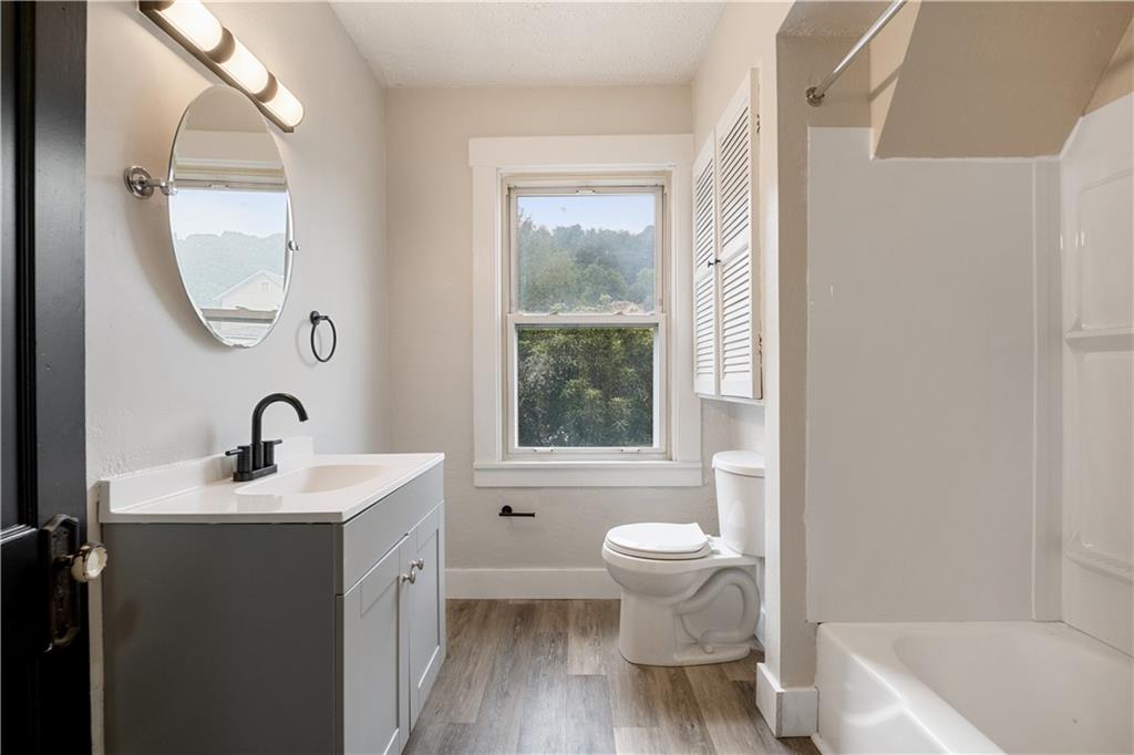 1306 Broadway Avenue McKees Rocks, PA 15136 - Photo 20 of 33 a bathroom with a sink a toilet and a mirror
