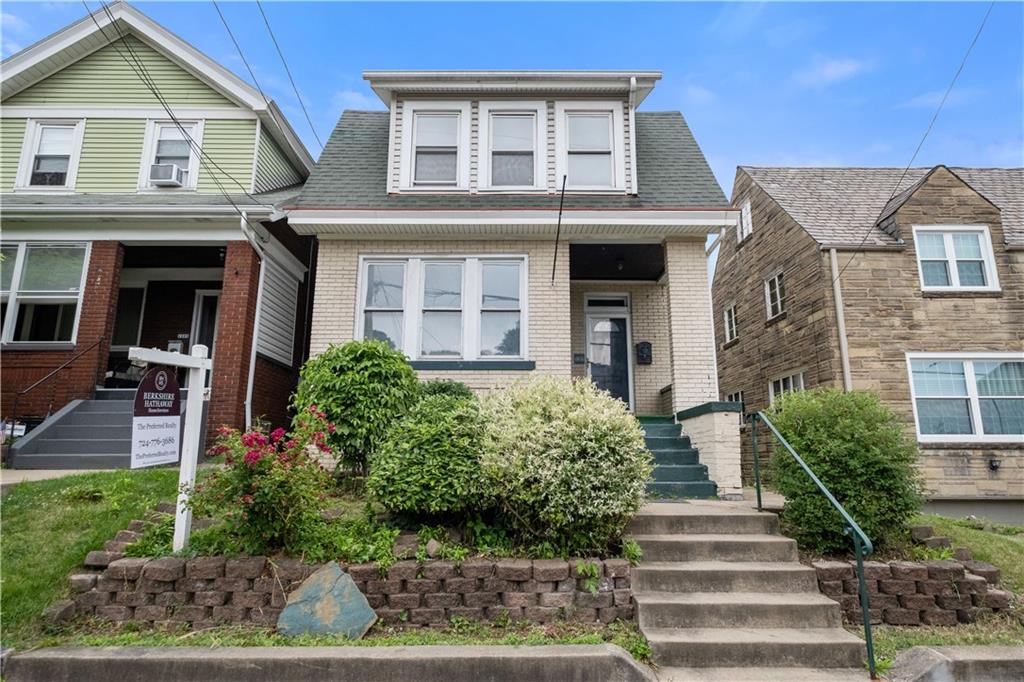 1306 Broadway Avenue McKees Rocks, PA 15136 - Photo 2 of 33 a front view of a house with plants and garden