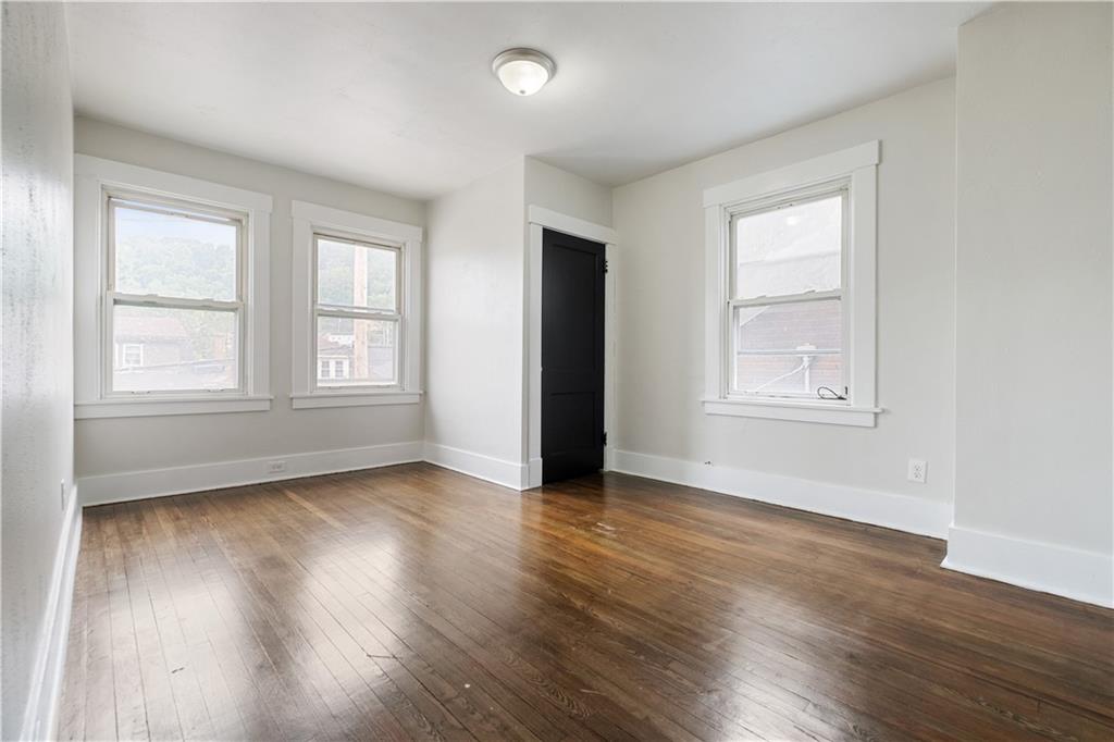 1306 Broadway Avenue McKees Rocks, PA 15136 - Photo 21 of 33 an empty room with wooden floor and windows