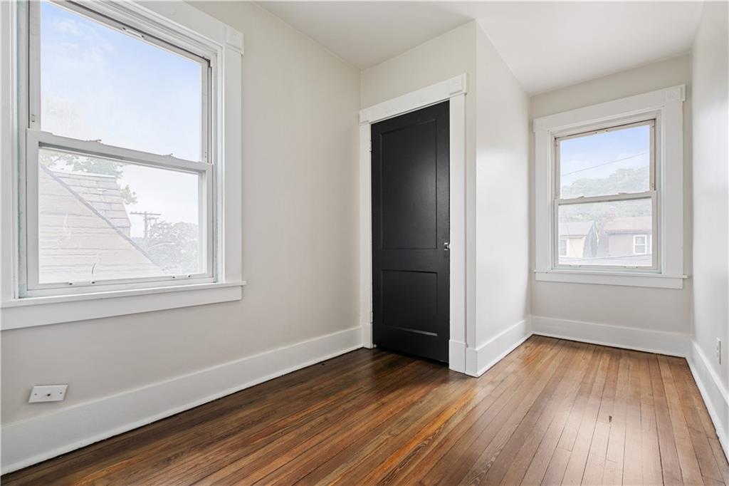 1306 Broadway Avenue McKees Rocks, PA 15136 - Photo 22 of 33 an empty room with wooden floor and windows