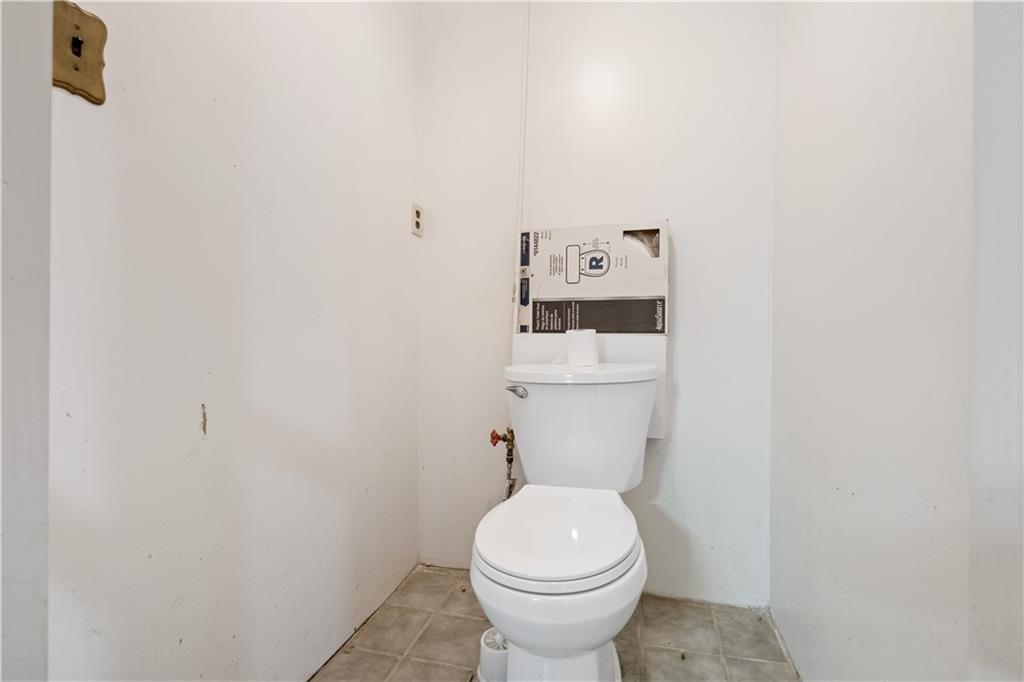 1306 Broadway Avenue McKees Rocks, PA 15136 - Photo 25 of 33 a white toilet sitting next to a white wall