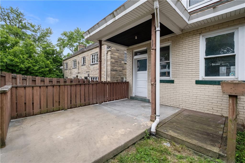 1306 Broadway Avenue McKees Rocks, PA 15136 - Photo 30 of 33 a view of a house with backyard and wooden fence