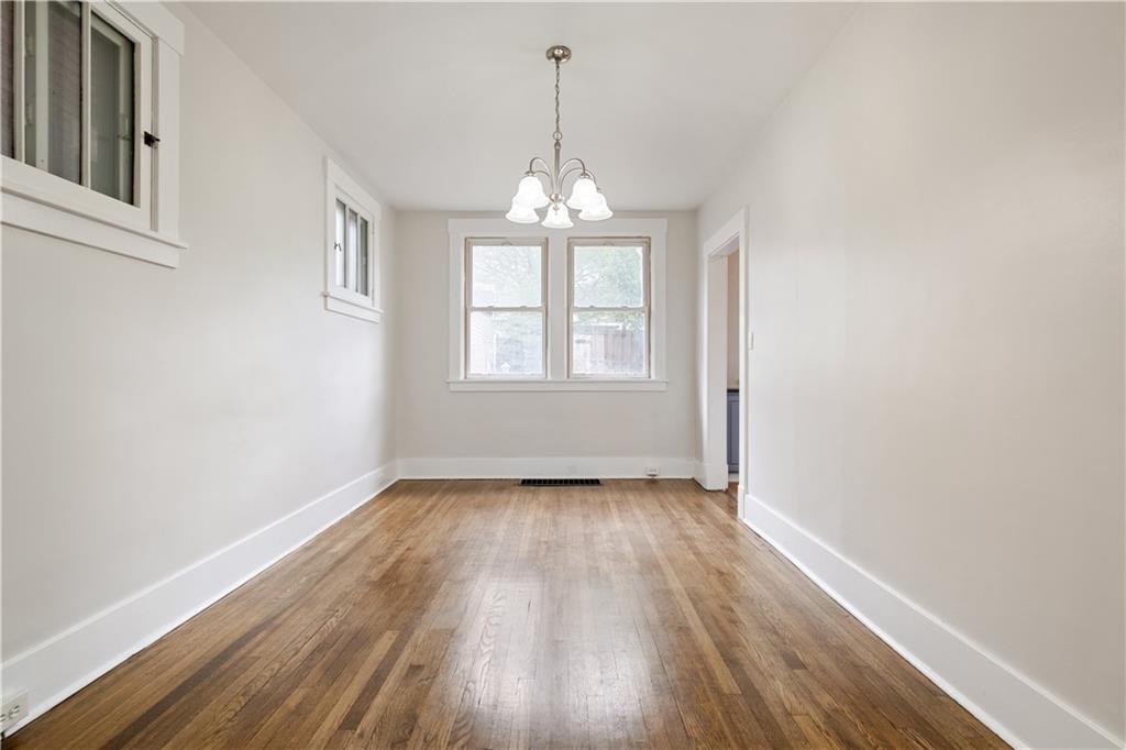 1306 Broadway Avenue McKees Rocks, PA 15136 - Photo 9 of 33 an empty room with wooden floor exposed radiator and windows
