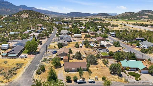 132 Rex Layne Drive Central, UT 84722 - Photo 37 of 39 Aerial perspective of a neighborhood featuring single-story homes, surrounded by natural desert landscaping and distant mountains