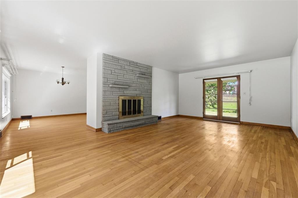 524 McElheny Road Glenshaw, PA 15116 - Photo 8 of 41 an empty room with wooden floor fireplace and windows