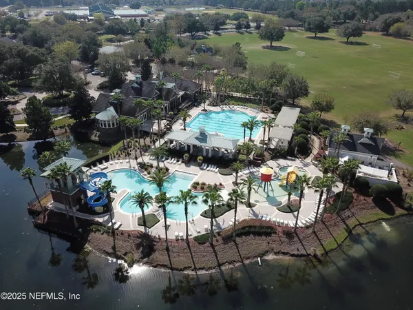 an aerial view of a house with garden space and lake view