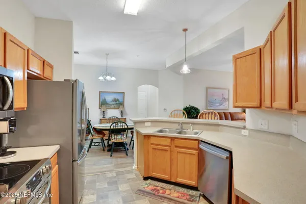 a dining room with furniture and a large window