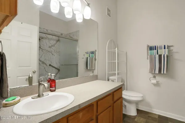an aerial view of a house with a yard swimming pool and outdoor seating