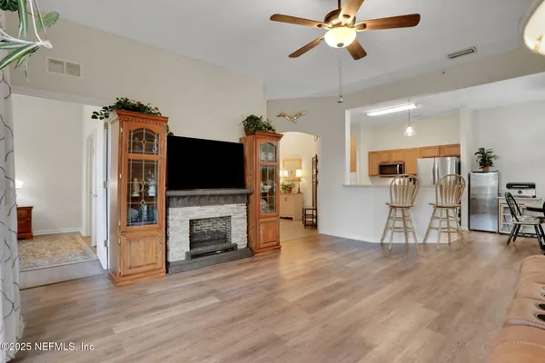 a living room with furniture fireplace and flat screen tv