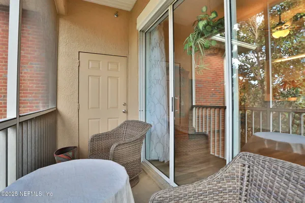 a kitchen with stainless steel appliances kitchen island granite countertop a refrigerator a stove a microwave oven a dining table and chairs with wooden floor