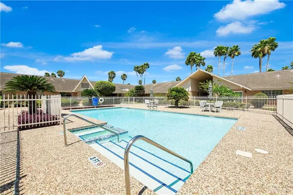 a view of a swimming pool with a lounge chair