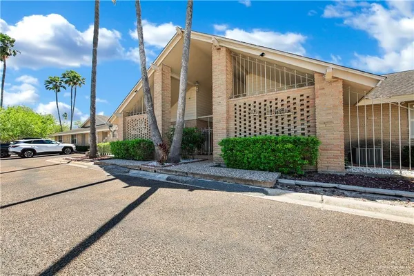 a view of a patio with a table and chairs