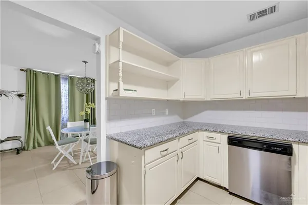 a kitchen with a sink a stove and cabinets