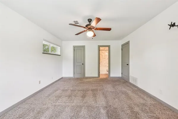 a view of a livingroom with a ceiling fan and window