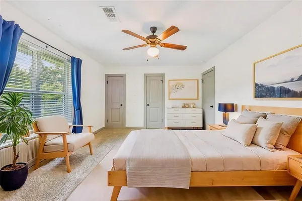 a bedroom with a bed and a chandelier