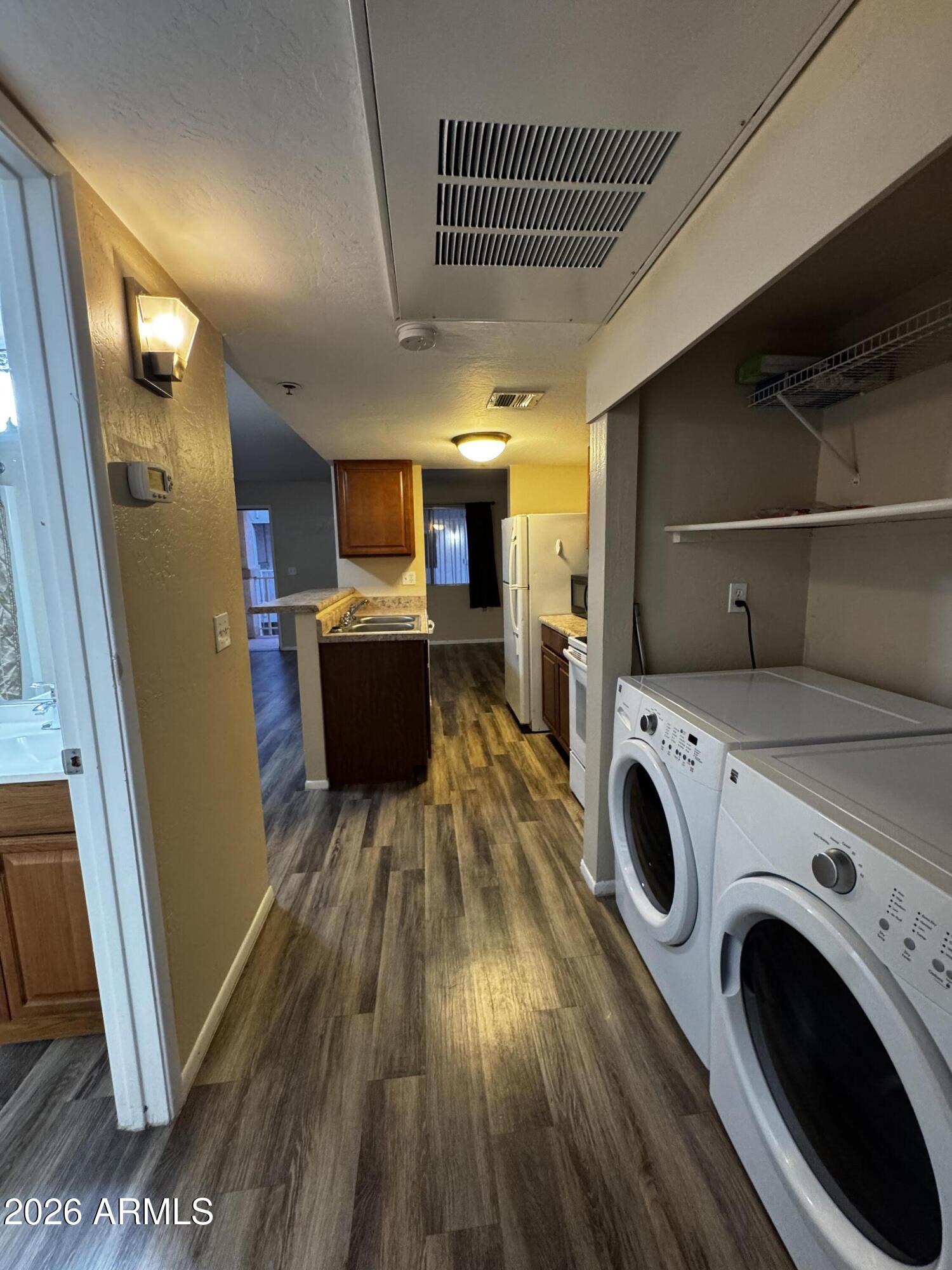 12123 West Bell Road, Unit 258 Surprise, AZ 85378 - Photo 7 of 30 a view of kitchen with washer and dryer